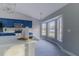 Bright dining area adjacent to the kitchen, featuring large windows and wood-look tile flooring at 75 Pine Crse, Ocala, FL 34472