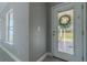 Bright entryway showcasing a wreath on the door and neutral wall paint at 75 Pine Crse, Ocala, FL 34472