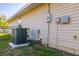 View of the home's HVAC system on a poured concrete pad, set near a black metal fence at 75 Pine Crse, Ocala, FL 34472