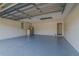 Spacious two car garage featuring a door to inside, epoxy floor and storage at 75 Pine Crse, Ocala, FL 34472