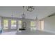 Open-concept kitchen with a large island featuring modern fixtures, plenty of natural light, and access to the dining area at 75 Pine Crse, Ocala, FL 34472
