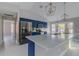 Bright kitchen featuring blue cabinets, stainless steel appliances, a large island, and modern pendant lighting at 75 Pine Crse, Ocala, FL 34472