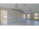 Large open living area featuring wood-look tile floors, vaulted ceilings, and an abundance of natural light at 75 Pine Crse, Ocala, FL 34472