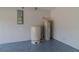 The utility room features epoxy floor, water pressure tank and water heater at 75 Pine Crse, Ocala, FL 34472