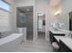 Modern bathroom features a soaking tub, glass shower, and double vanity, creating a spa-like retreat at 7635 Nw 33Rd Pl, Ocala, FL 34482