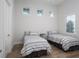 Bright bedroom with natural light, wood floors, and neutral décor, a serene and inviting space at 7635 Nw 33Rd Pl, Ocala, FL 34482