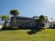 Back exterior view of home with pool, screened enclosure, lush landscaping and well-manicured lawn at 7635 Nw 33Rd Pl, Ocala, FL 34482