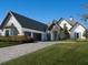 Charming home with a stone entryway, a three-car garage and well-maintained landscaping at 7635 Nw 33Rd Pl, Ocala, FL 34482
