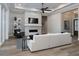 Inviting living room features a stylish fireplace, modern furniture, and hardwood floors at 7635 Nw 33Rd Pl, Ocala, FL 34482