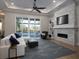 Bright living room with modern fireplace, large windows, and hardwood floors at 7635 Nw 33Rd Pl, Ocala, FL 34482