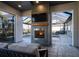 Enjoy the warmth of the outdoor fireplace with a TV, relaxing views of the pool, and golf course at 7635 Nw 33Rd Pl, Ocala, FL 34482