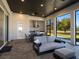 Inviting covered outdoor living area featuring a full kitchen, ceiling fan and beautiful golf course views at 7635 Nw 33Rd Pl, Ocala, FL 34482