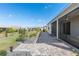 Landscaped backyard featuring a brick paver patio, screened in porch, and mature landscaping elements at 7698 Sw 85Th Cir, Ocala, FL 34481