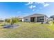 Well-maintained lawn with a screened-in lanai and decorative landscaping creates a serene backyard at 7698 Sw 85Th Cir, Ocala, FL 34481