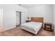 Bedroom with light brown carpet, queen-size bed, and side tables at 7698 Sw 85Th Cir, Ocala, FL 34481