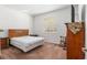 Bedroom featuring a wood bed frame, rocking chair, and bedside tables at 7698 Sw 85Th Cir, Ocala, FL 34481