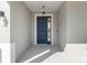 Elegant blue front door with sidelight and decorative hardware, under a covered porch at 7698 Sw 85Th Cir, Ocala, FL 34481