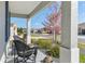 Covered porch with stylish seating and view of the well maintained landscaped front yard at 7698 Sw 85Th Cir, Ocala, FL 34481