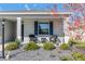 Inviting front porch featuring comfortable seating, meticulous landscaping and classic shutters at 7698 Sw 85Th Cir, Ocala, FL 34481