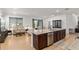 Open concept kitchen featuring granite countertops and stainless steel appliances, adjoining living area at 7698 Sw 85Th Cir, Ocala, FL 34481