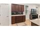 Kitchen featuring dark wood cabinets, granite countertops, tile backsplash, and modern appliances at 7698 Sw 85Th Cir, Ocala, FL 34481