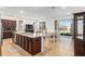 Bright kitchen features a large island, stainless appliances, and easy access to both the living and dining areas at 7698 Sw 85Th Cir, Ocala, FL 34481