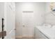Bright laundry room with white washer and dryer with access to storage at 7698 Sw 85Th Cir, Ocala, FL 34481