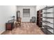 Cozy living room featuring comfortable seating, shelving, and natural light through the window at 7698 Sw 85Th Cir, Ocala, FL 34481