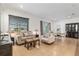 Open-concept living room with dining area featuring elegant furnishings and abundant natural light at 7698 Sw 85Th Cir, Ocala, FL 34481