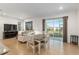 Bright and airy living room with access to the patio and an adjacent dining area for entertaining at 7698 Sw 85Th Cir, Ocala, FL 34481