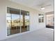 Sliding glass doors offer access to a screened patio, perfect for relaxation, with views of the lawn and landscaping at 7698 Sw 85Th Cir, Ocala, FL 34481