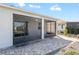 Rear view of home highlighting the expansive screened lanai, exterior lighting, hardscape and mature landscaping at 7698 Sw 85Th Cir, Ocala, FL 34481