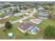 Aerial view of a residential area featuring a screened-in pool, spacious yards, and tree-lined streets at 7955 Sw 62Nd Ct, Ocala, FL 34476