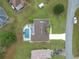 Birds eye view of home with screened pool, showcasing the roof, driveway, and tidy landscaping at 7955 Sw 62Nd Ct, Ocala, FL 34476