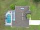 Overhead photo of a home with a screened pool, featuring well-maintained roof, and green grass at 7955 Sw 62Nd Ct, Ocala, FL 34476