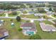 Expansive aerial view of a community featuring a home with a screened pool and well-manicured lawn at 7955 Sw 62Nd Ct, Ocala, FL 34476