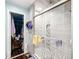 Modern bathroom features glass shower, tiled walls, and walk-in closet at 7955 Sw 62Nd Ct, Ocala, FL 34476