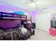 A bedroom with a bunk bed, closet and ceiling fan with lights at 7955 Sw 62Nd Ct, Ocala, FL 34476