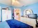 Bright bedroom features a ceiling fan, dresser, and a glimpse into an adjacent kitchen area at 7955 Sw 62Nd Ct, Ocala, FL 34476