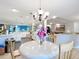 Bright dining area with chandelier lighting and elegant table setting that looks to the kitchen at 7955 Sw 62Nd Ct, Ocala, FL 34476