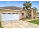 Inviting home exterior showcasing a well-maintained lawn and a convenient attached two-car garage at 7955 Sw 62Nd Ct, Ocala, FL 34476