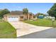 Attractive single-story home with a well-kept lawn and a spacious driveway leading to a two-car garage at 7955 Sw 62Nd Ct, Ocala, FL 34476