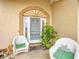 Welcoming front porch with seating, greenery, and charming details around the front door at 7955 Sw 62Nd Ct, Ocala, FL 34476