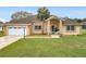 Charming single Gathering home featuring a well-manicured lawn and attached two-car garage at 7955 Sw 62Nd Ct, Ocala, FL 34476