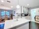 Bright kitchen with quartz countertops, hardwood floors, and adjacent dining area provides a cozy atmosphere at 7955 Sw 62Nd Ct, Ocala, FL 34476