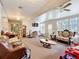 Bright and open living room with lots of seating, a ceiling fan and bright lights at 7955 Sw 62Nd Ct, Ocala, FL 34476