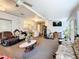 Spacious living room area filled with plenty of seating, ceiling fans, and a TV at 7955 Sw 62Nd Ct, Ocala, FL 34476