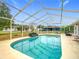 Refreshing screened-in pool with inviting, clear water and a spacious deck for lounging at 7955 Sw 62Nd Ct, Ocala, FL 34476