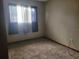 Comfortable bedroom featuring plush carpeting, a neutral paint scheme, and natural light from the window, ready for relaxation at 8344 Sw 107Th Pl, Ocala, FL 34481