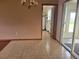Inviting dining area featuring tile flooring, a classic chandelier, and a view to a sunroom through glass doors at 8344 Sw 107Th Pl, Ocala, FL 34481